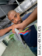 installing an electric wire at work. Стоковое фото, агентство Ingram Publishing / Фотобанк Лори