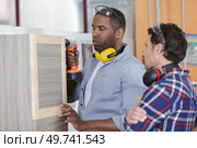 carpenter with apprentices building furniture in workshop. Стоковое фото, агентство Ingram Publishing / Фотобанк Лори