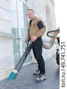 street cleaner works with a vacuum cleaner on the street. Стоковое фото, агентство Ingram Publishing / Фотобанк Лори