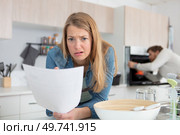 woman looking at letter with an expression of dismay. Стоковое фото, агентство Ingram Publishing / Фотобанк Лори