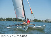 catamaran sailing boat and man in a sunny day. Стоковое фото, агентство Ingram Publishing / Фотобанк Лори