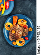 Tasty grilled meat,roasted with pineapple on stone background. Grilled steak and ananas. Top view.. Grilled meat steak with ananas. Стоковое фото, агентство Ingram Publishing / Фотобанк Лори