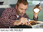male electrician checking the cables. Стоковое фото, агентство Ingram Publishing / Фотобанк Лори
