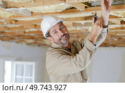 portrait of a man working on a ceiling. Стоковое фото, агентство Ingram Publishing / Фотобанк Лори