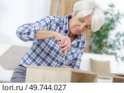 a woman fixing a furniture. Стоковое фото, агентство Ingram Publishing / Фотобанк Лори