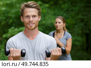 man working out biceps in outdoors. Стоковое фото, агентство Ingram Publishing / Фотобанк Лори