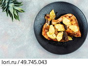 Spicy chicken legs fried with pineapple pieces. Baked chicken meat. Space for text.. Barbecued chicken drumsticks and pineapple. Стоковое фото, агентство Ingram Publishing / Фотобанк Лори