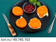 Tasty Camembert baked in breading with fruit sauce. Breakfast.. Fried Camembert cheese with sauce. Стоковое фото, агентство Ingram Publishing / Фотобанк Лори