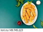 Crumbed fried fish fingers in sticks with sauce. Restaurant menu, cookbook recipe. Copy space.. Cod fish nuggets. Стоковое фото, агентство Ingram Publishing / Фотобанк Лори