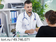 male doctor listen carefully patient complaints. Стоковое фото, агентство Ingram Publishing / Фотобанк Лори