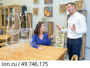 woman trying to convince husband to buy table. Стоковое фото, агентство Ingram Publishing / Фотобанк Лори