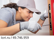 female lock smith posing and smiling. Стоковое фото, агентство Ingram Publishing / Фотобанк Лори
