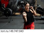 Female martial artist training in a gym shadowboxing trowing a uppercut. Female martial artist training in a gym. Стоковое фото, агентство Ingram Publishing / Фотобанк Лори
