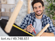 man carpenter working in furniture repair workshop. Стоковое фото, агентство Ingram Publishing / Фотобанк Лори
