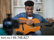 a handsome man recording song vlogging concept. Стоковое фото, агентство Ingram Publishing / Фотобанк Лори