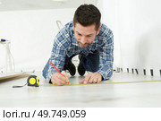 carpenter during installation of parquet. Стоковое фото, агентство Ingram Publishing / Фотобанк Лори