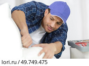 man repair a armchair at his worshop. Стоковое фото, агентство Ingram Publishing / Фотобанк Лори