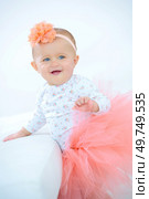 a smiling baby wearing tutu. Стоковое фото, агентство Ingram Publishing / Фотобанк Лори