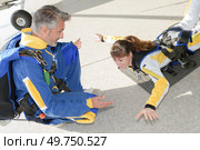 Lady practicing position for parachute jump. Стоковое фото, агентство Ingram Publishing / Фотобанк Лори