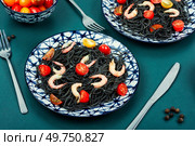 Vegan black bean spaghetti with shrimp and tomatoes.. Vegan spaghetti with shrimp. Стоковое фото, агентство Ingram Publishing / Фотобанк Лори