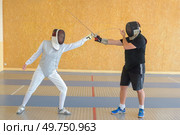 two people and fencing dual. Стоковое фото, агентство Ingram Publishing / Фотобанк Лори
