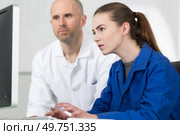 instructor helping student with work project. Стоковое фото, агентство Ingram Publishing / Фотобанк Лори