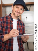 portrait of professional male worker with clipboard indoors. Стоковое фото, агентство Ingram Publishing / Фотобанк Лори