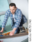man laying laminated flooring. Стоковое фото, агентство Ingram Publishing / Фотобанк Лори