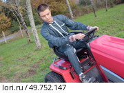 a man is maneuvering mower. Стоковое фото, агентство Ingram Publishing / Фотобанк Лори