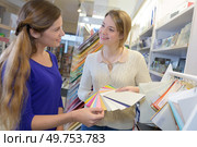 two female designers in office looking at different samples. Стоковое фото, агентство Ingram Publishing / Фотобанк Лори