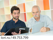 senior and young working together on a project. Стоковое фото, агентство Ingram Publishing / Фотобанк Лори
