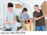 couple moving in a new house and closing carton boxes. Стоковое фото, агентство Ingram Publishing / Фотобанк Лори