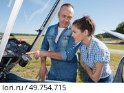 man showing woman the controls of a sailplane. Стоковое фото, агентство Ingram Publishing / Фотобанк Лори