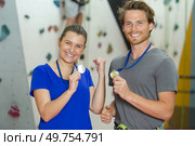 male and female climbers showing off their winners medals. Стоковое фото, агентство Ingram Publishing / Фотобанк Лори