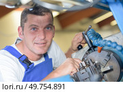a blacksmith fixing a machine. Стоковое фото, агентство Ingram Publishing / Фотобанк Лори