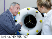 a male airplane maintenance worker with apprentice. Стоковое фото, агентство Ingram Publishing / Фотобанк Лори