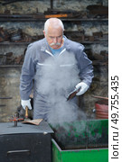 senior tinsmith working in his workshop. Стоковое фото, агентство Ingram Publishing / Фотобанк Лори