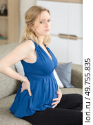 young pregnant woman suffering from backache at home. Стоковое фото, агентство Ingram Publishing / Фотобанк Лори