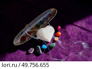 seven chakras signs and stone heart with flower of life pattern. seven chakras stones, energy healing concept. Стоковое фото, агентство Ingram Publishing / Фотобанк Лори