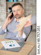 businessman receiving envelope while calling on phone. Стоковое фото, агентство Ingram Publishing / Фотобанк Лори