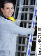 happy woman standing on a ladders. Стоковое фото, агентство Ingram Publishing / Фотобанк Лори