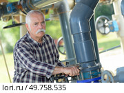 mature man standing on waste water treatment unit. Стоковое фото, агентство Ingram Publishing / Фотобанк Лори