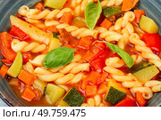 Preparing delicious minestrone soup made from seasonal vegetables and pasta. Close up. Vegetable soup with macaroni, Minestrone. Стоковое фото, агентство Ingram Publishing / Фотобанк Лори