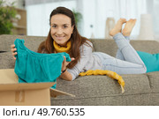 happy beautiful woman happily received clothing parcel. Стоковое фото, агентство Ingram Publishing / Фотобанк Лори