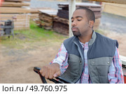 a worker carfeully maneuvering vehicle. Стоковое фото, агентство Ingram Publishing / Фотобанк Лори