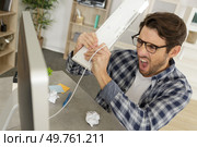 angry and upset man wants to break his pc. Стоковое фото, агентство Ingram Publishing / Фотобанк Лори