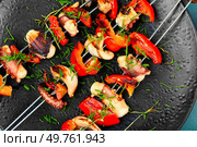 Grilled octopus skewers garnished with bell pepper. Seafood. Close up.. A plate of octopus skewers. Стоковое фото, агентство Ingram Publishing / Фотобанк Лори