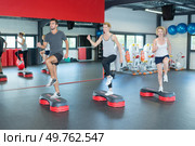 happy people doing indoor biking in a fitness club. Стоковое фото, агентство Ingram Publishing / Фотобанк Лори