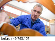 portrait of senior master craftsman building a chair. Стоковое фото, агентство Ingram Publishing / Фотобанк Лори