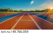 A tennis court with red clay surface and white lines, ready for players to compete in a match under the bright sun.. Tennis Court With Red Clay and White Lines. Стоковое фото, агентство Ingram Publishing / Фотобанк Лори